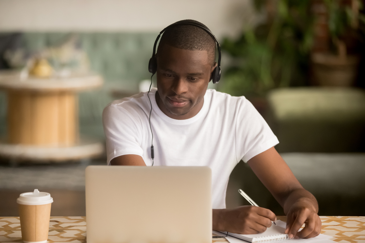 Student at computer with headphones