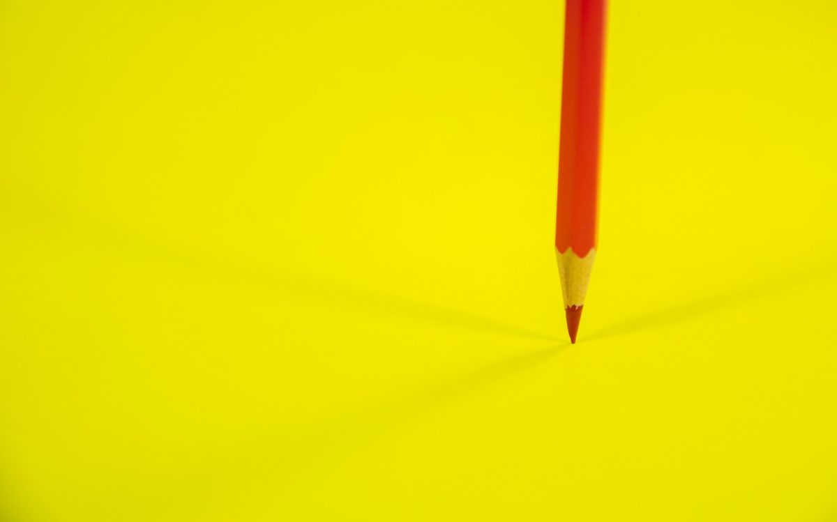 Red pen on yellow background