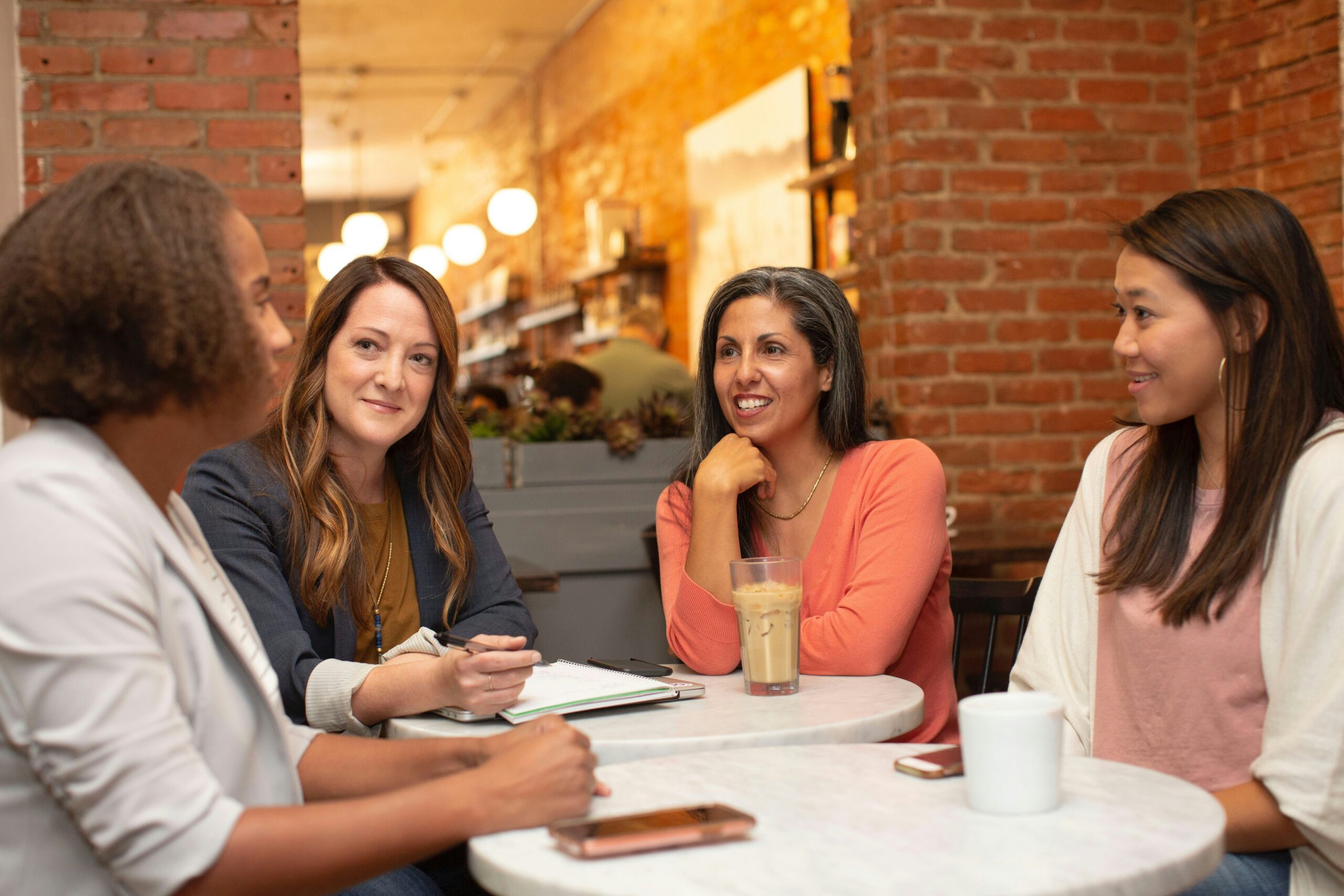 Four faculty members talking around a table.