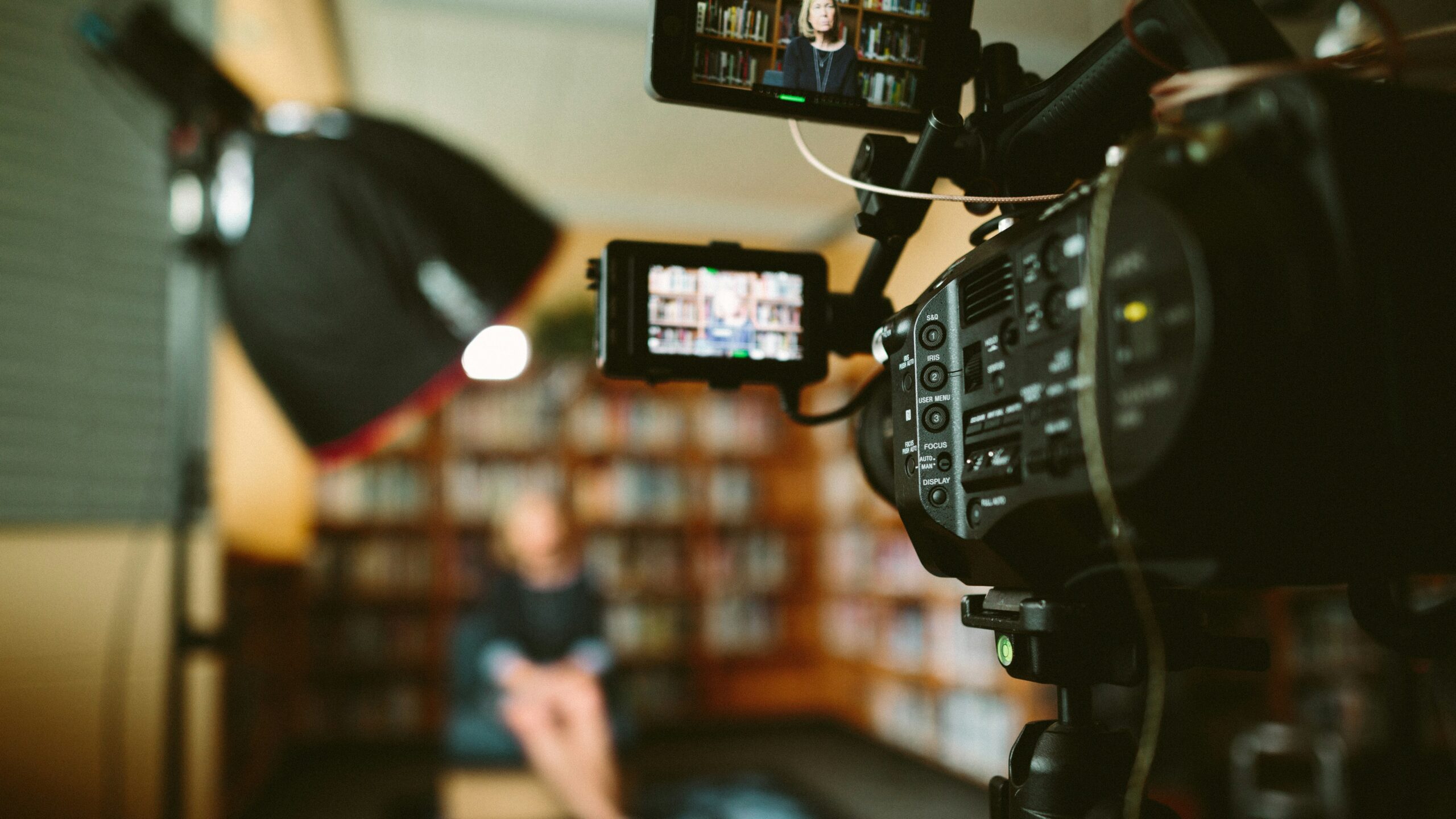 A video camera recording a presentation.